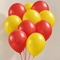 Realistic red and yellow balloons against a neutral wall