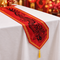 Red Chinese dragon table runner with the pointed end draping over the table edge, square format