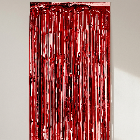 Red foil curtain against a neutral wall with natural light and soft shadows, in square format
