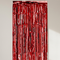 Red foil curtain against a neutral wall with natural light and soft shadows, in square format