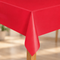 Red plastic table cover on a table with a wooden leg, square format