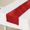 Red sequin table runner in a neutral room