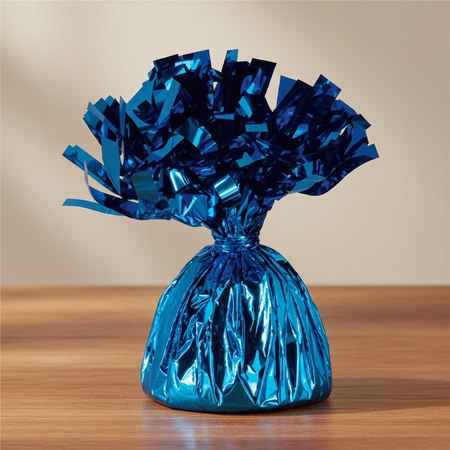 Royal blue balloon weight on a wood table with a neutral background