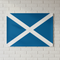 Scotland flag poster on a white brick wall