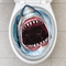 Shark sticker applied to a toilet seat, viewed from above