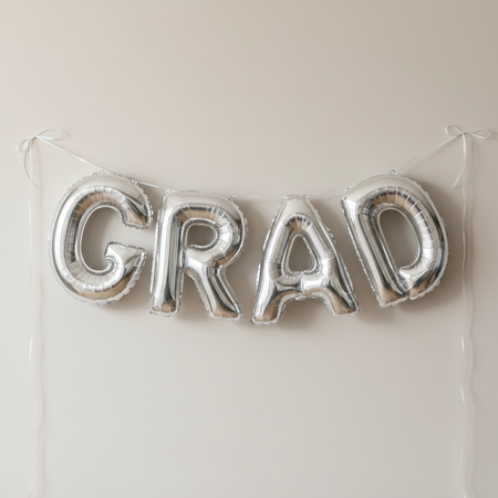 Silver GRAD Foil Balloons Hung as Bunting on Wall