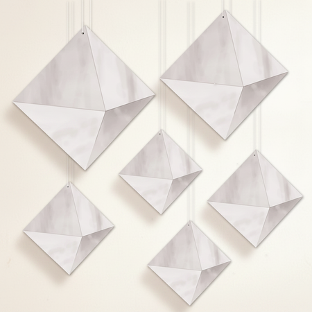 Silver hanging decorations on an off-white wall