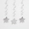 Silver hanging star swirls against a white wall