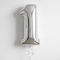 Silver number 1 balloon floating with silver curling ribbon against a softly lit white wall, close up in square format