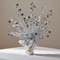 Silver starburst spray centrepiece on a white-clothed table