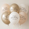 Six birthday balloons floating with cream curling ribbons against a softly lit neutral background, square format