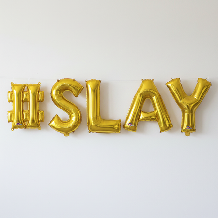 #SLAY Gold Balloons Against Wall