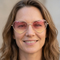 Square close-up of someone wearing the pink and yellow ombré heart-shaped glasses