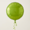 Square close-up of the lime green foil balloon floating with matching curling ribbon against a softly lit neutral background