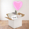 Square pink heart balloon gift using the previous image’s wooden floor and white wall background reference