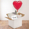 Square red heart balloon gift using the previous image’s wooden floor and white wall background reference