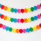 Three paper balloon garlands on a plain white wall, with alternating colours and no door surround