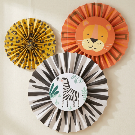 Three safari paper fans against a cream wall with soft light and shade, in square format