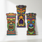 Three Tiki Cutouts Against Wall with Light and Shade