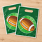 Two American football gift bags fanned out on a wooden table, viewed from above in square format