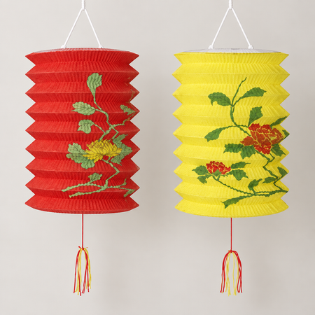 Two floral paper lanterns, red and yellow, hanging close up against a neutral background, square format