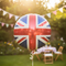 Union Jack Foil Balloon with Ribbon and Blurred Garden Background