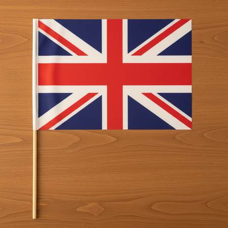 Union Jack Hand Waving Flag Flat Lay on Wood Table