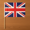 Union Jack Hand Waving Flag Flat Lay on Wood Table
