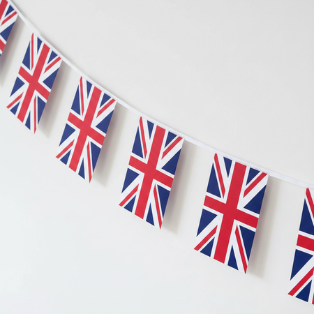 Union Jack Paper Bunting Diagonal Angle Against White Wall