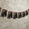Updated bunting on the stone wall with clear white bias binding across the tops of the pennants