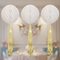 White honeycomb tissue balls with gold tassels and background
