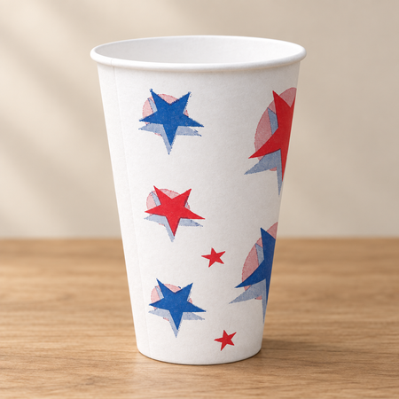 White paper cup with red and blue stars on a wood table