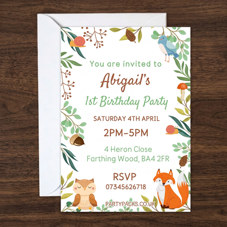 Woodland invitation and envelope on a dark walnut wood background in square format