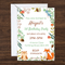 Woodland invitation and envelope on a dark walnut wood background in square format