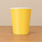 Yellow cup with more surrounding table visible